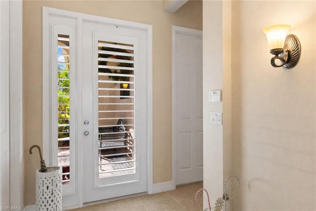 4339 Aurora Street Naples, FL 34119 - Photo 5 of 47 a view of a hallway with windows
