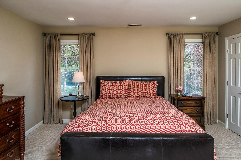 174 Marshall Ridge Road New Canaan, CT 06840 - Photo 21 of 30 a large bedroom with a bed and wooden floor