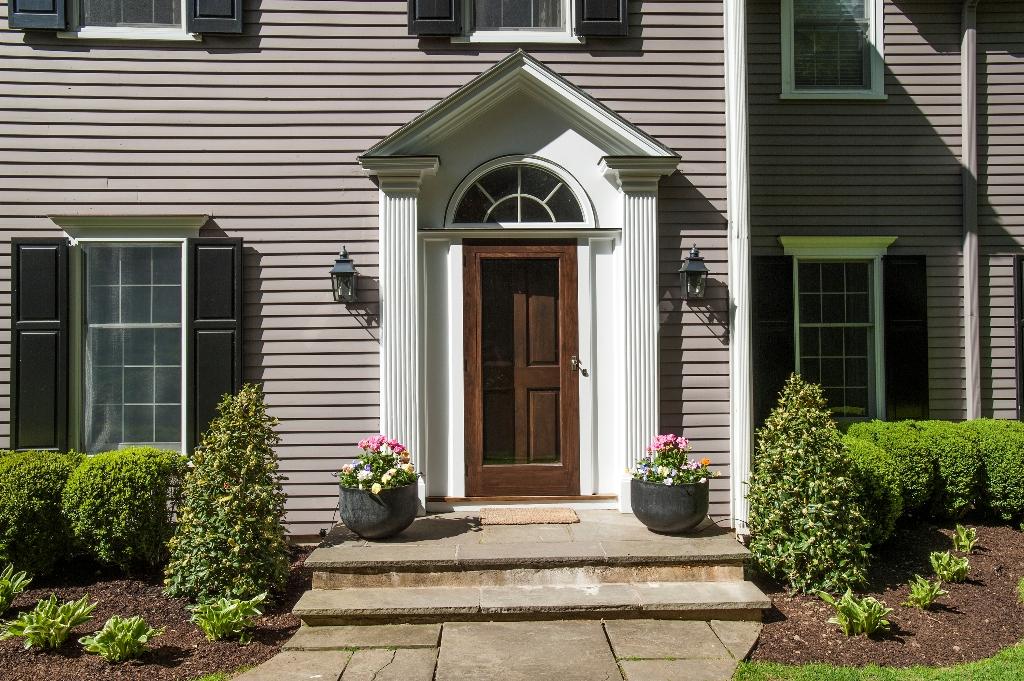 174 Marshall Ridge Road New Canaan, CT 06840 - Photo 3 of 30 a front view of a house with garden