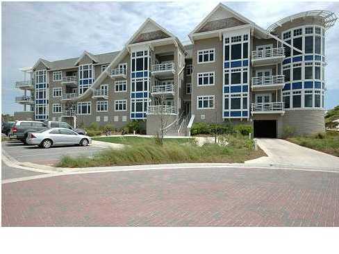 99 Compass Point Way, Unit 206 Watersound, FL 32461 - Photo 1 of 1 a front view of a residential apartment building with a yard and plants
