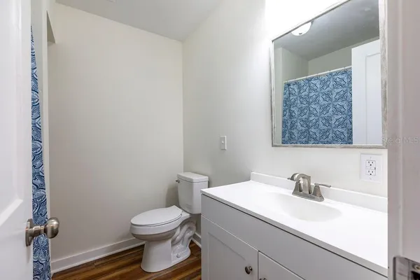 a bathroom with a sink a toilet and a mirror