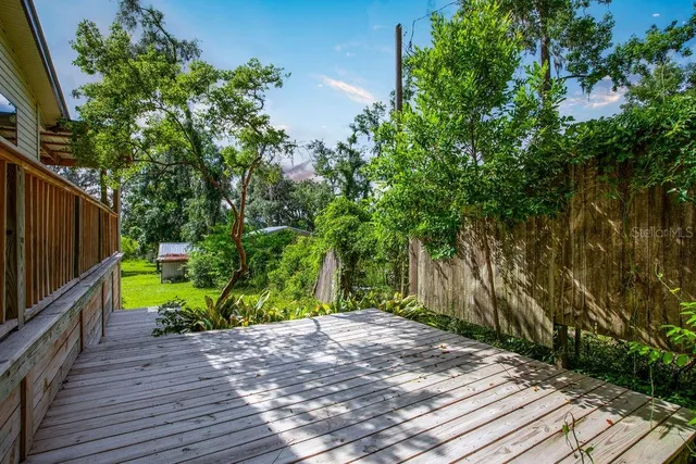 a view of a backyard with wooden fence