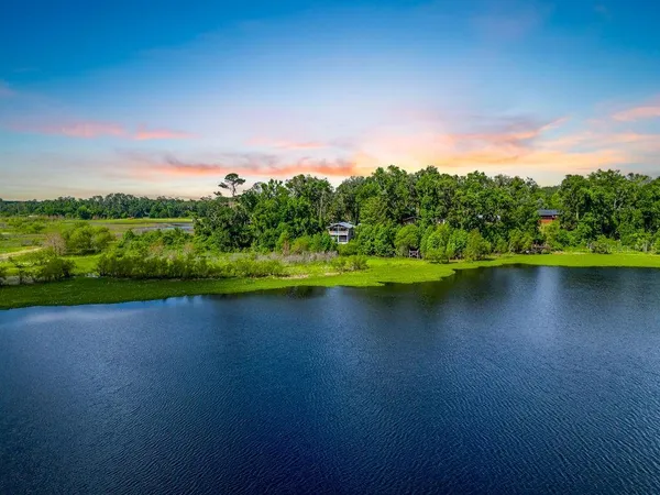 a view of a lake with houses in the back