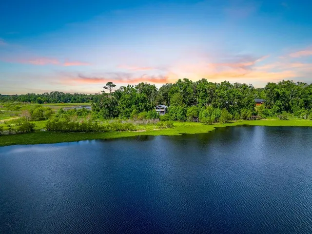 a view of a lake with houses in the back