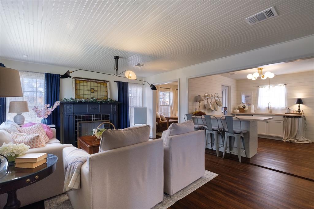 2040 South 9th Street Waco, TX 76706 - Photo 4 of 25 a living room with furniture a fireplace and a kitchen view