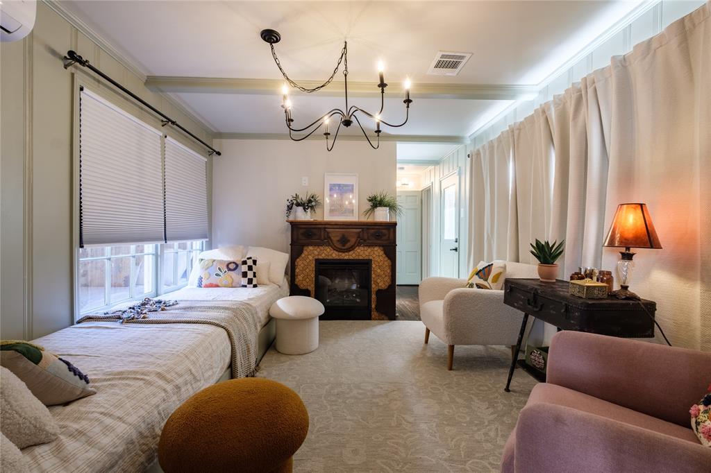 2040 South 9th Street Waco, TX 76706 - Photo 9 of 25 a bedroom with furniture and a fireplace