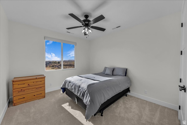404 North Marsala Way St. George, UT 84770 - Photo 22 of 26 Bedroom with light colored carpet and ceiling fan