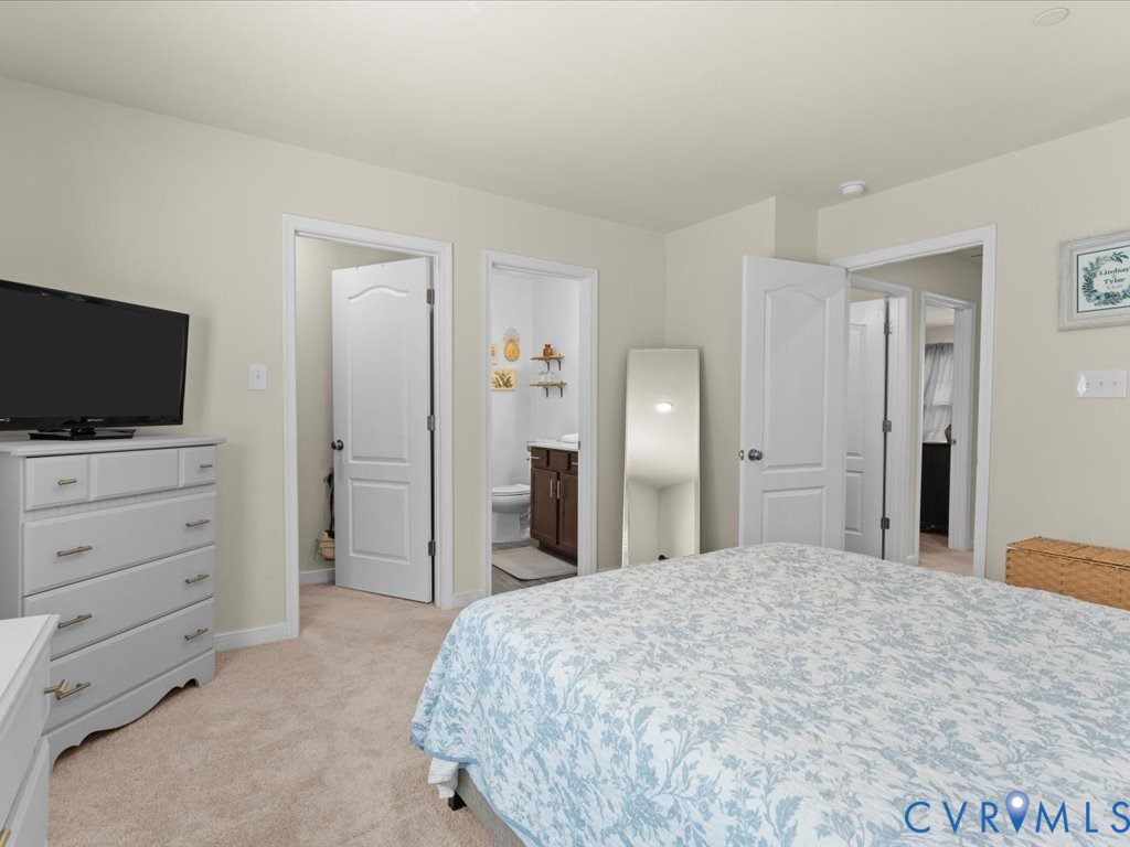 12137 Perdue Springs Loop Chester, VA 23831 - Photo 26 of 45 Bedroom with light colored carpet and connected ba
