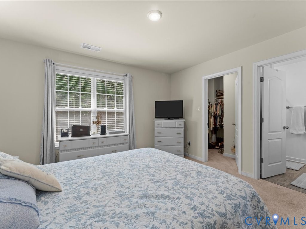 12137 Perdue Springs Loop Chester, VA 23831 - Photo 28 of 45 Bedroom featuring a walk in closet, light colored