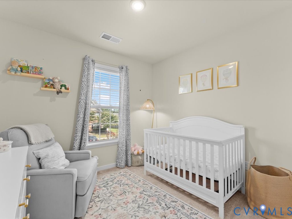 12137 Perdue Springs Loop Chester, VA 23831 - Photo 31 of 45 Bedroom featuring light carpet and a nursery area