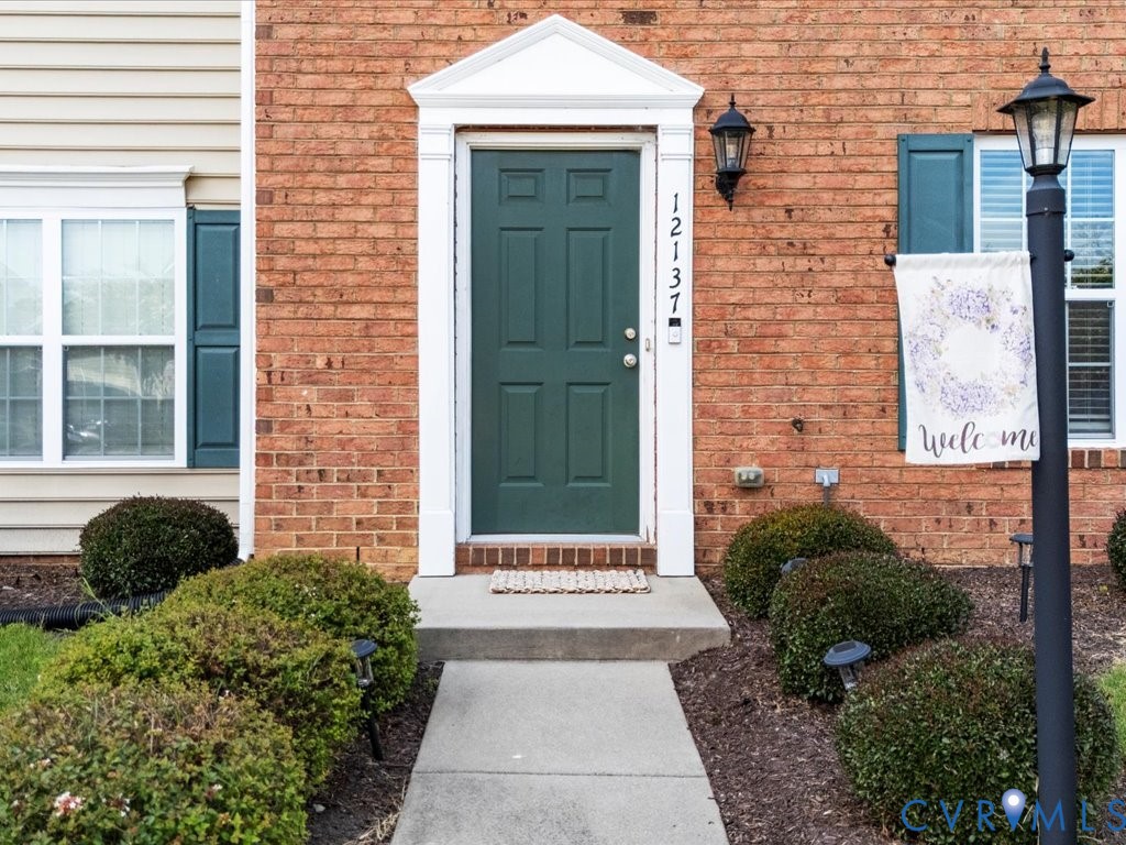 12137 Perdue Springs Loop Chester, VA 23831 - Photo 4 of 45 View of exterior entry with brick siding