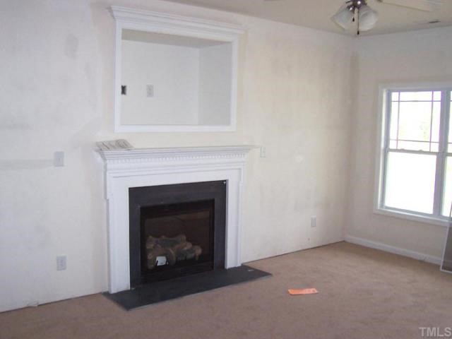 3219 Sunbright Lane Raleigh, NC 27610 - Photo 2 of 11 a living room with a fireplace