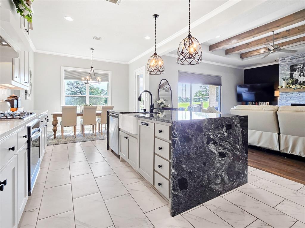 1008 Henry Way Springtown, TX 76082 - Photo 15 of 40 a large white kitchen with a large window and stainless steel appliances