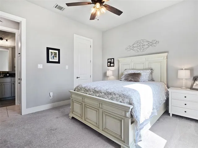 a bedroom with a bed and a ceiling fan