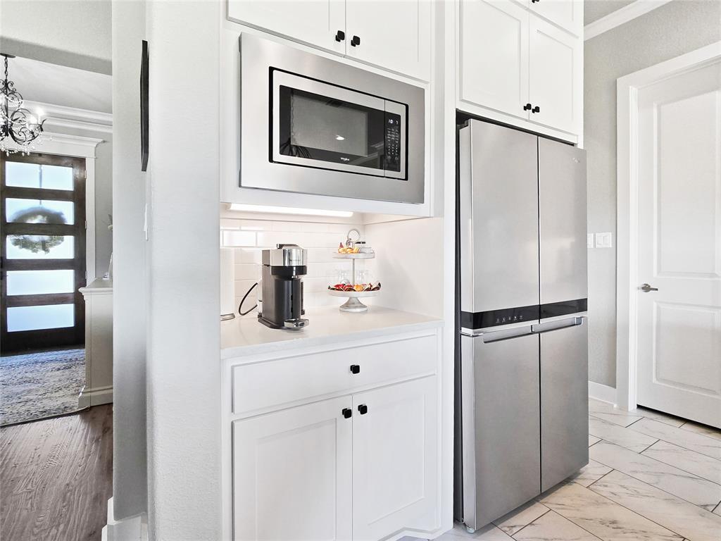 1008 Henry Way Springtown, TX 76082 - Photo 21 of 40 a kitchen with a refrigerator sink and cabinets