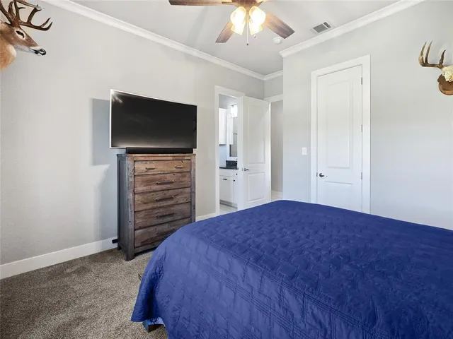a view of a bedroom with cabinet flat screen tv and closet