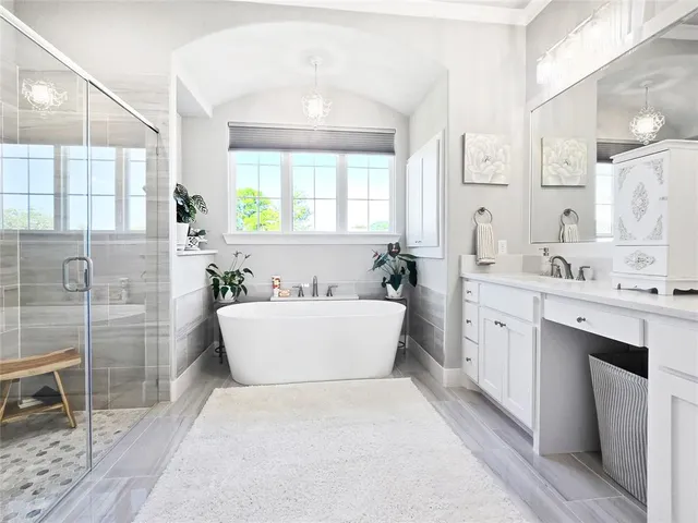 a bathroom with a tub sink and mirror