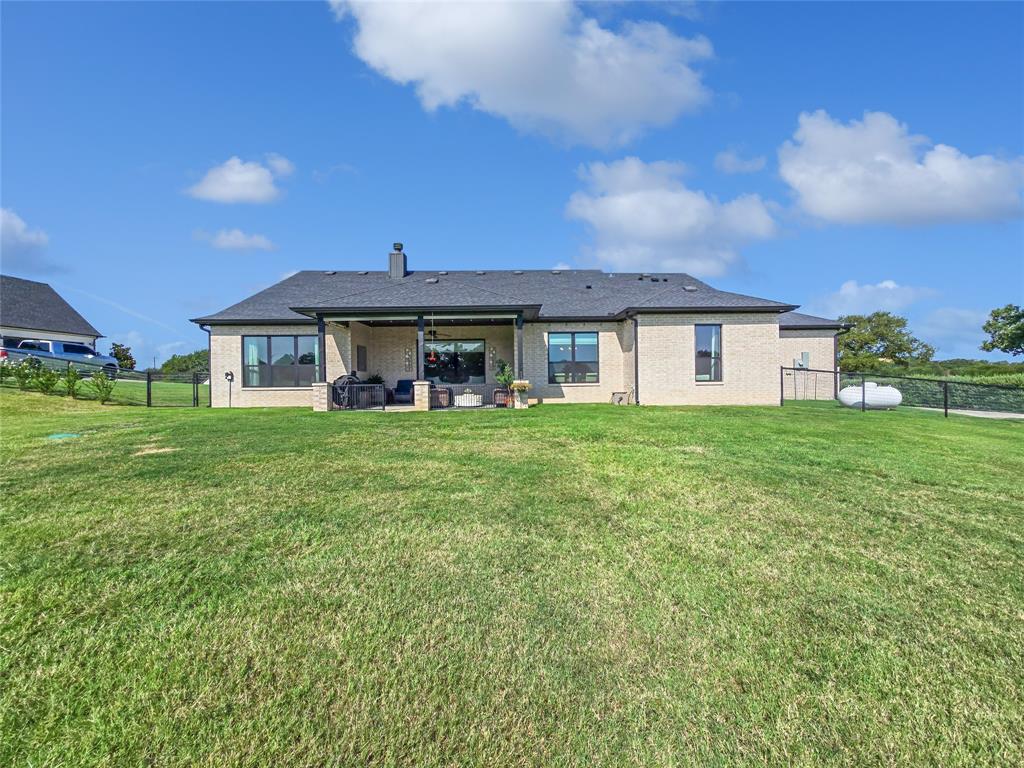1008 Henry Way Springtown, TX 76082 - Photo 38 of 40 a front view of a house with garden