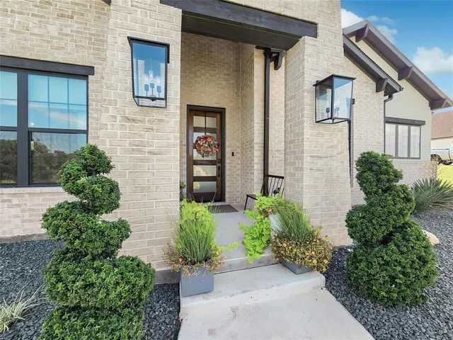 front view of a house with potted plants