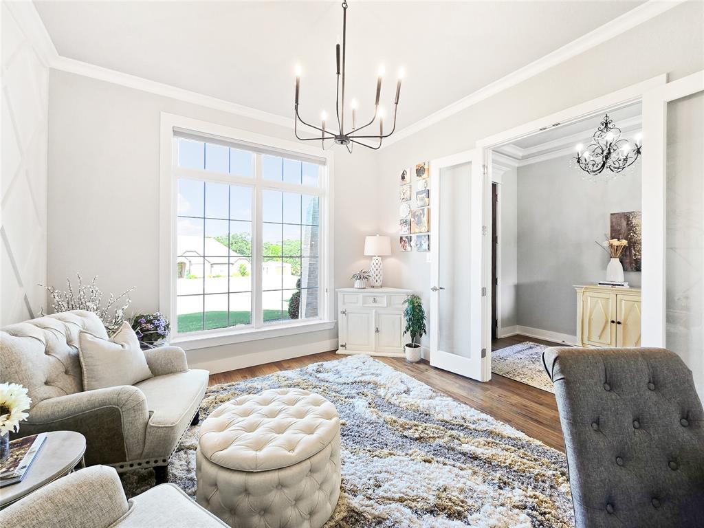 1008 Henry Way Springtown, TX 76082 - Photo 9 of 40 a living room with furniture a chandelier and a window