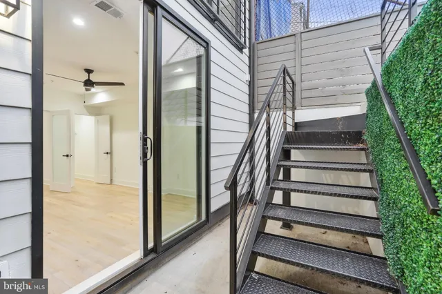 a view of entryway with wooden floor and stairs