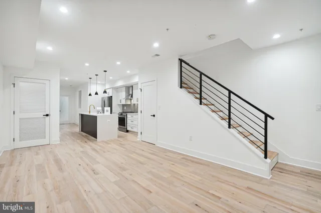 a view of a kitchen with furniture and wooden floor