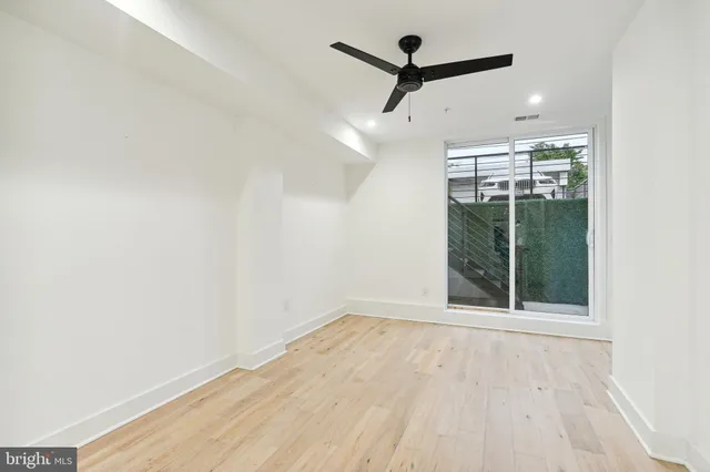 an empty room with windows and entrance