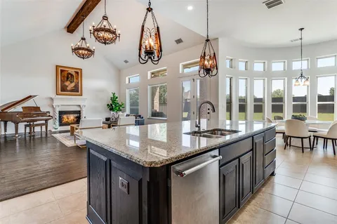 a kitchen with center island table and chairs