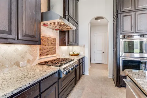 a kitchen with stainless steel appliances granite countertop a stove and a refrigerator