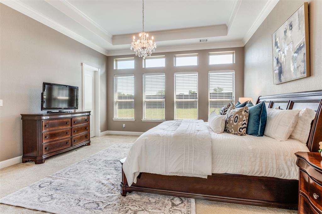 6809 Strauss Colleyville, TX 76034 - Photo 20 of 39 a bedroom with a bed and a flat tv screen on dresser