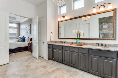 a spacious bathroom with a double vanity sink and a mirror