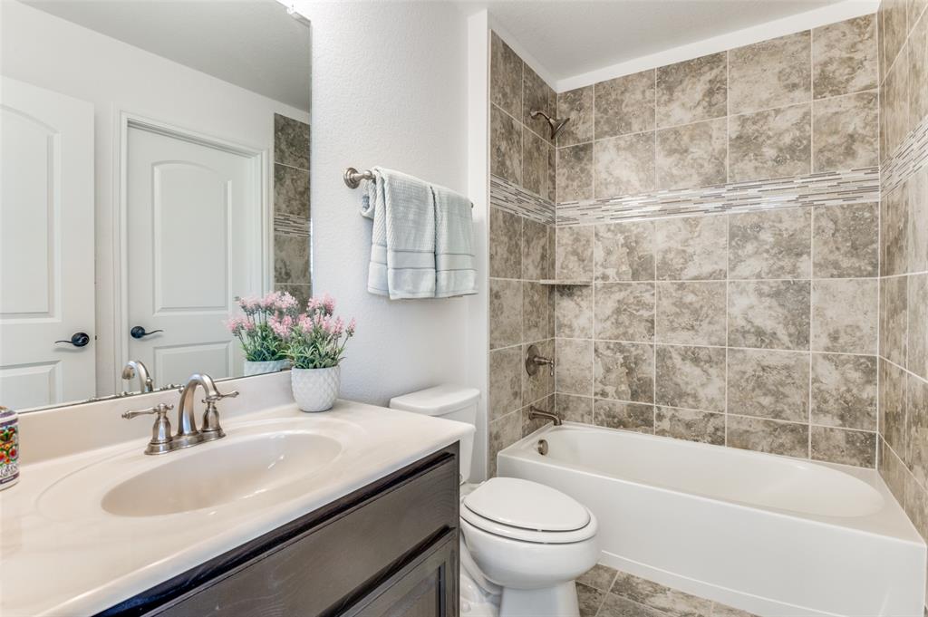 6809 Strauss Colleyville, TX 76034 - Photo 28 of 39 a bathroom with a sink toilet and shower