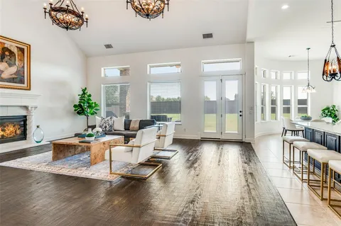 a living room with furniture wooden floor and a fireplace