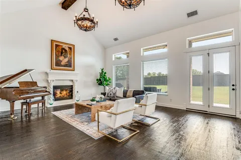 a living room with fireplace furniture and a wooden floor