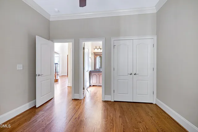 a view of a hallway with wooden floor