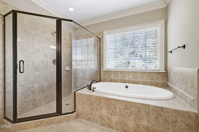 a spacious bathroom with a bathtub and shower