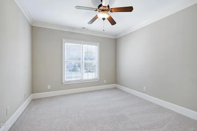 an empty room with chandelier fan