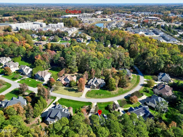 an aerial view of a houses with a yard