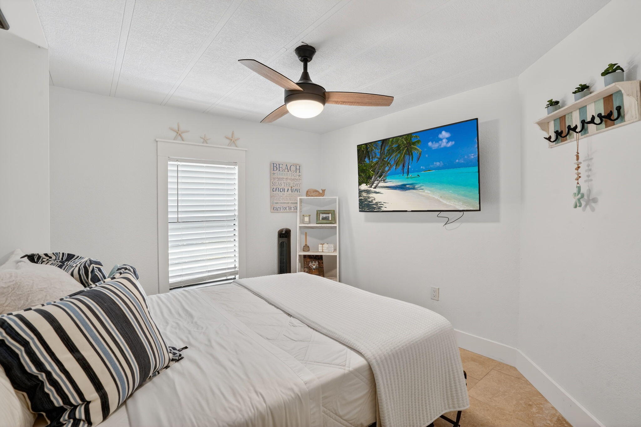 1127 Gulfstream Lane Key Largo, FL 33037 - Photo 13 of 40 a bedroom with a bed and a flat screen tv