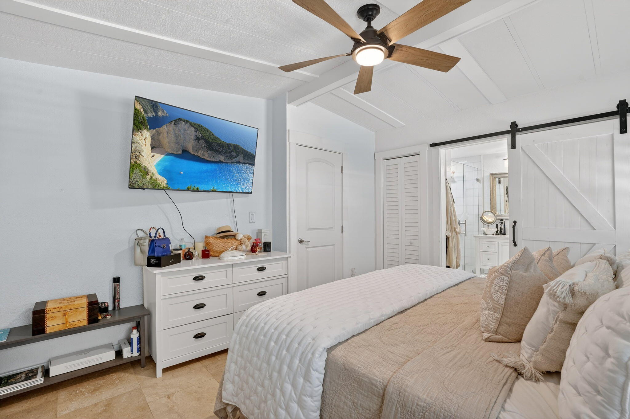 1127 Gulfstream Lane Key Largo, FL 33037 - Photo 17 of 40 a bedroom with a bed and a chandelier