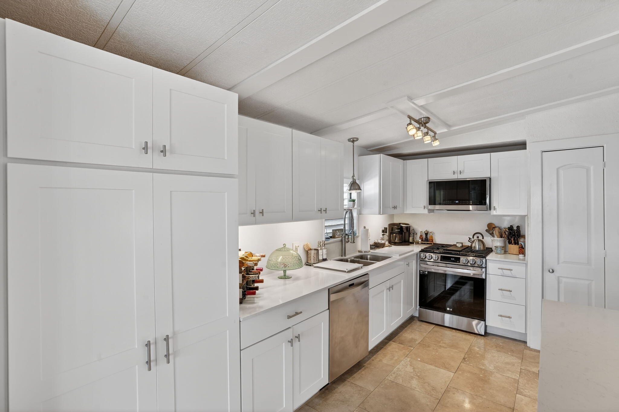 1127 Gulfstream Lane Key Largo, FL 33037 - Photo 9 of 40 a kitchen with white cabinets and appliances