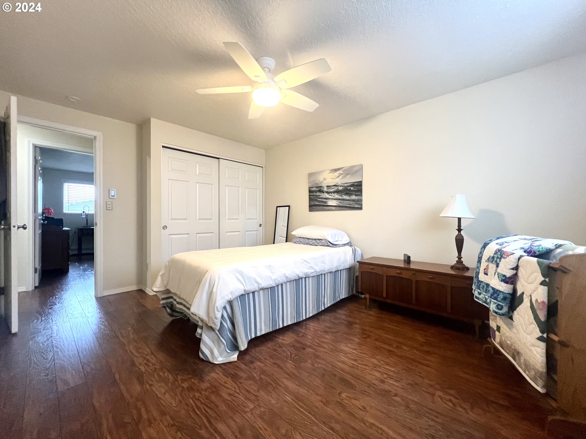 1644 Astor Way Woodburn, OR 97071 - Photo 15 of 28 a spacious bedroom with a bed and a chandelier