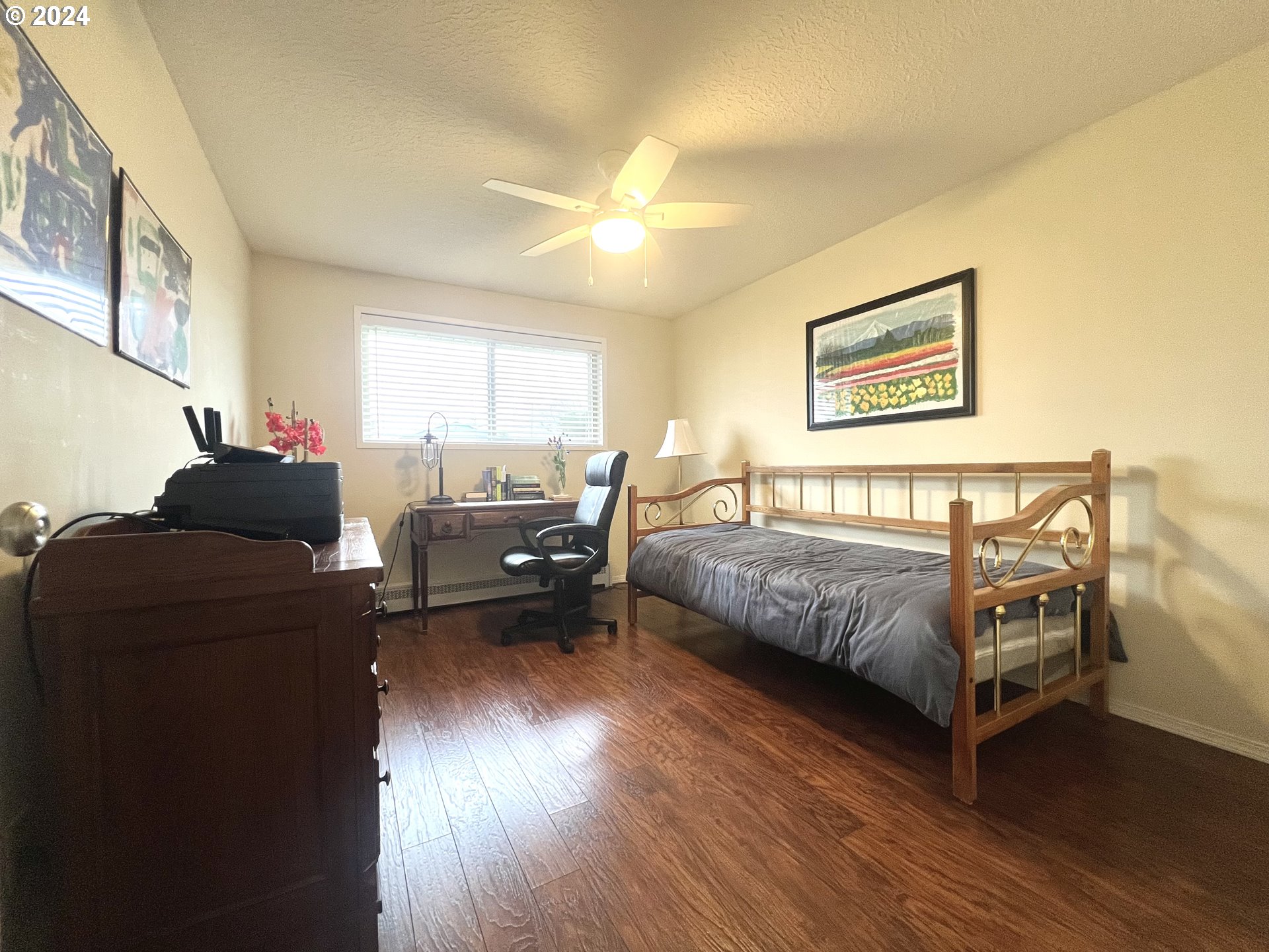 1644 Astor Way Woodburn, OR 97071 - Photo 17 of 28 a bedroom with a bed and wooden floor
