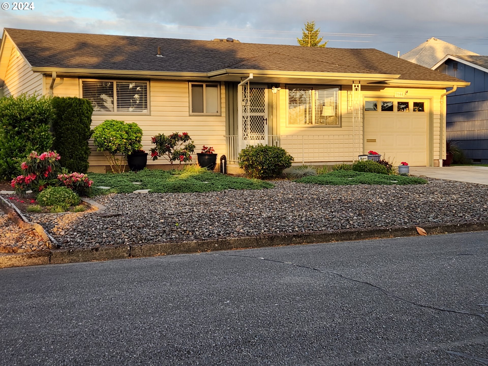 1644 Astor Way Woodburn, OR 97071 - Photo 3 of 28 a front view of a house with a yard and outdoor seating