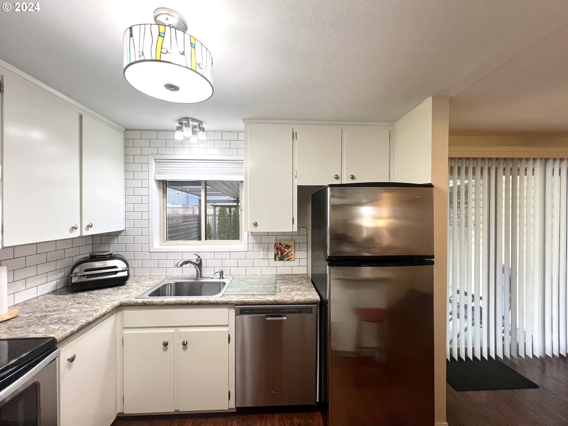1644 Astor Way Woodburn, OR 97071 - Photo 9 of 28 a kitchen with stainless steel appliances a sink stove and refrigerator