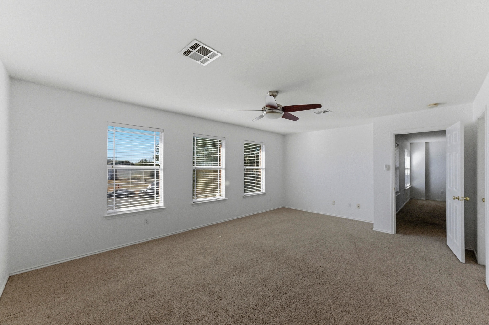 113 Spring Branch Cove Kyle, TX 78640 - Photo 14 of 33 Unfurnished room with ceiling fan and light colored carpet