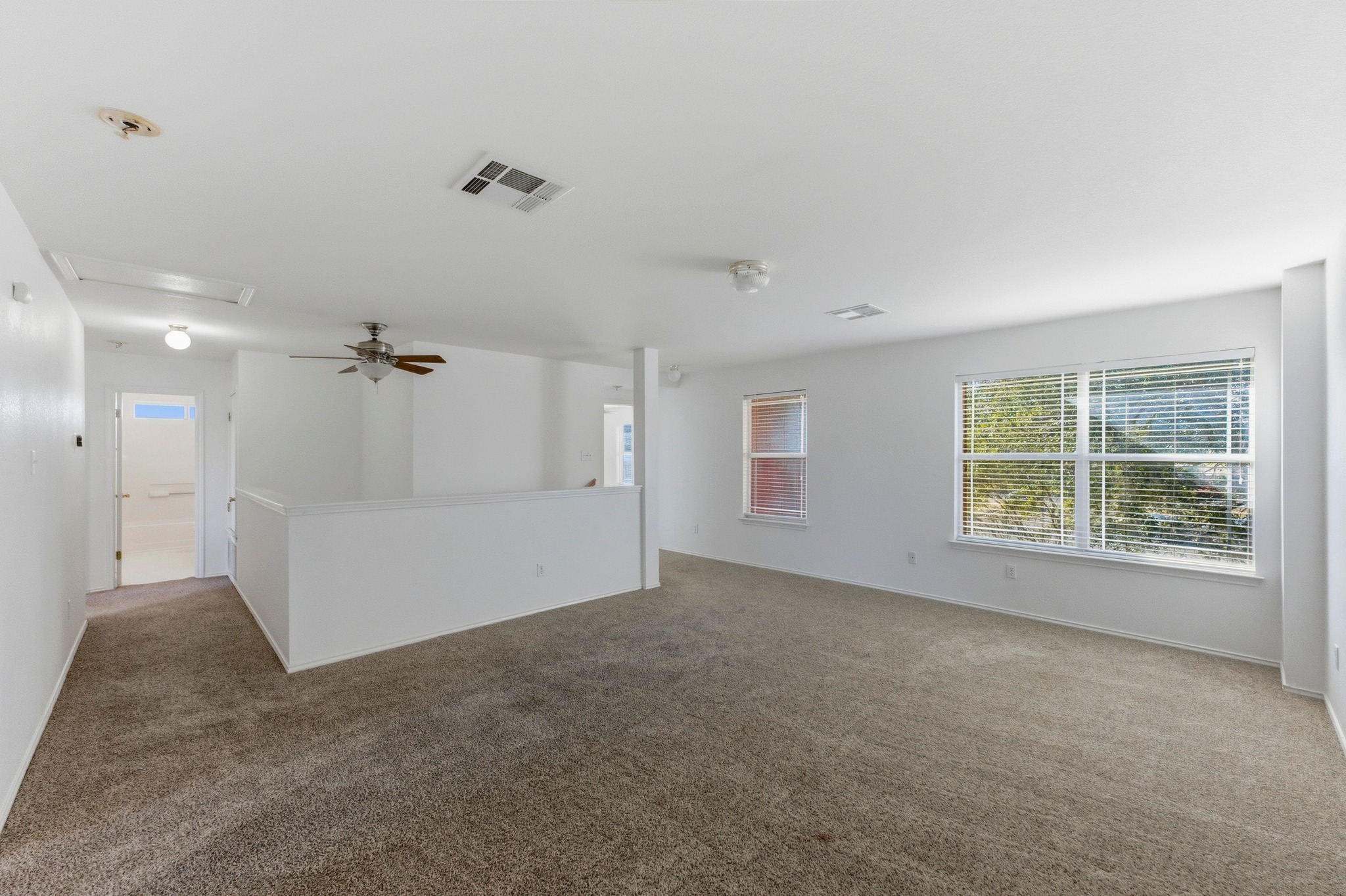 113 Spring Branch Cove Kyle, TX 78640 - Photo 19 of 33 Carpeted empty room with a ceiling fan and baseboards