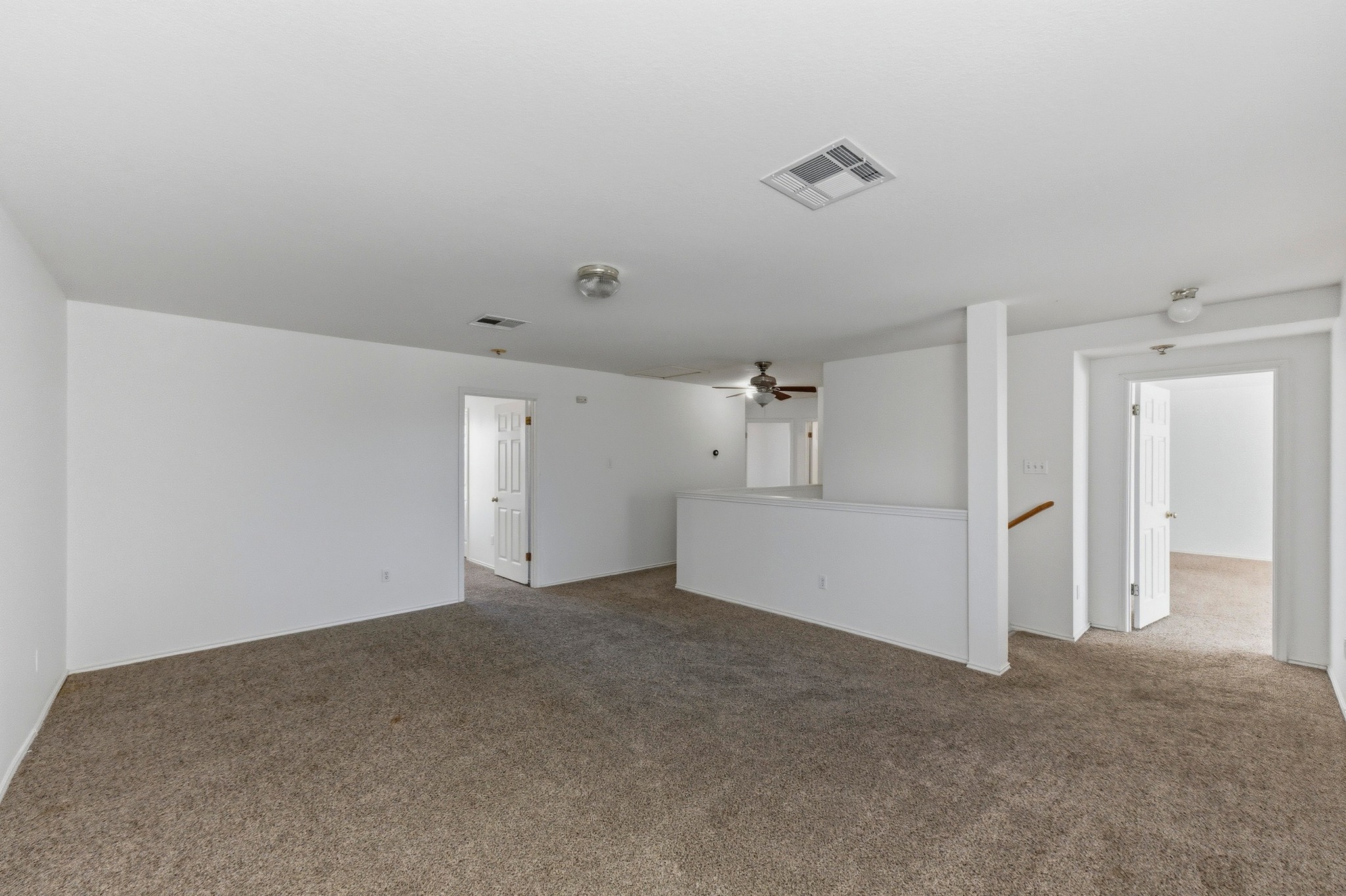 113 Spring Branch Cove Kyle, TX 78640 - Photo 21 of 33 Unfurnished living room featuring carpet and a ceiling fan