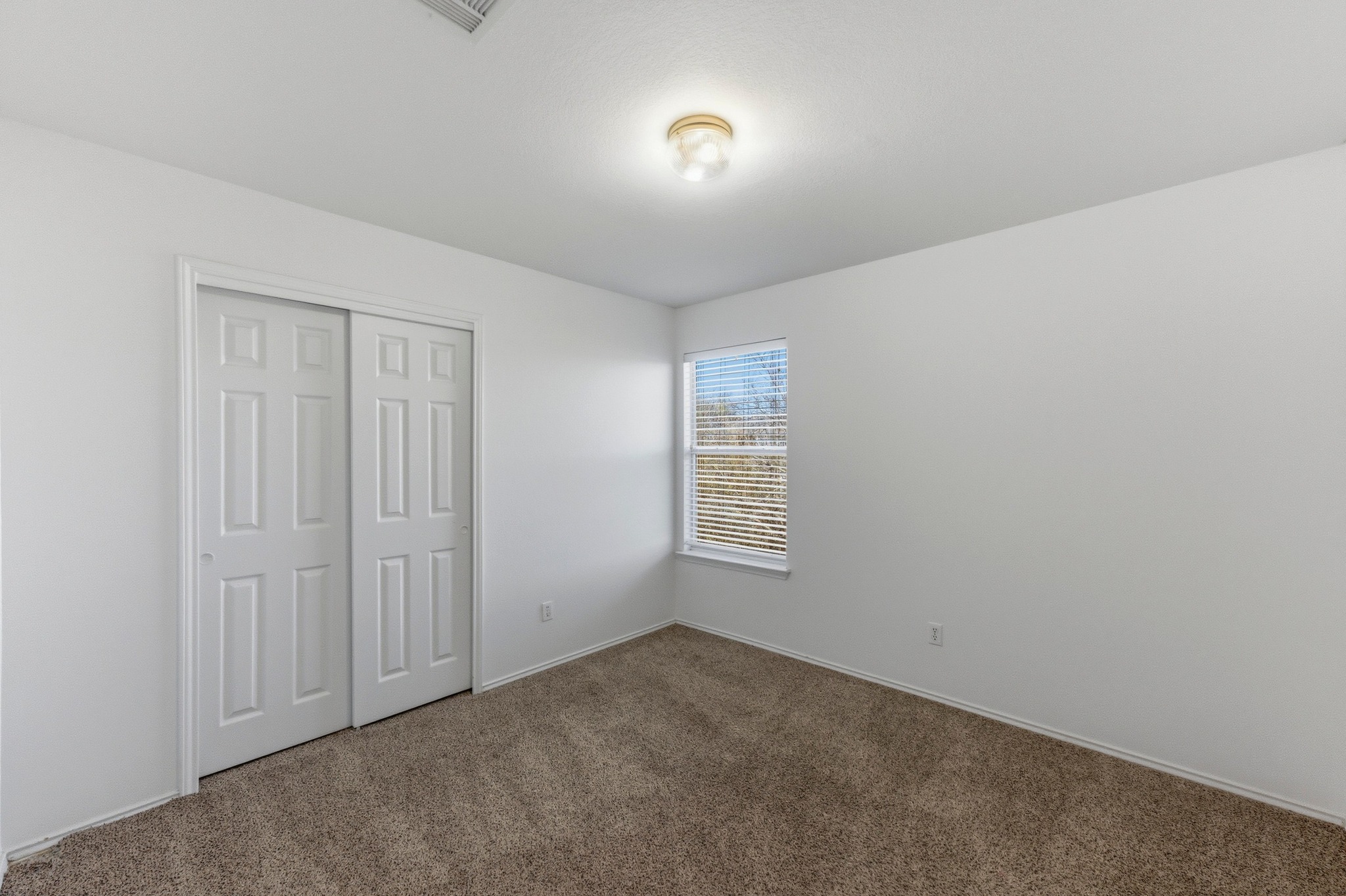 113 Spring Branch Cove Kyle, TX 78640 - Photo 23 of 33 Unfurnished bedroom with carpet floors and a closet