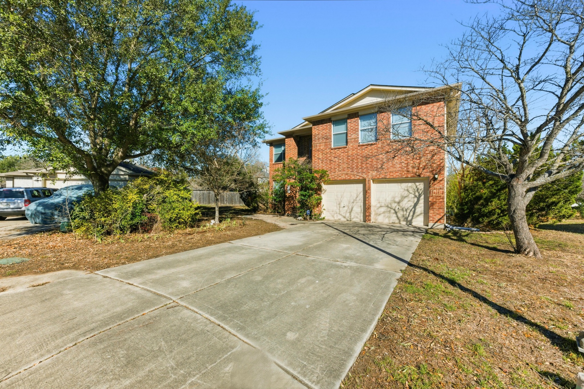 113 Spring Branch Cove Kyle, TX 78640 - Photo 3 of 33 View of front facade featuring an attached garage, brick siding, and driveway